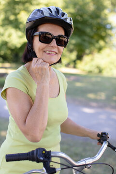 active senior woman standing outdoors on a road in nature