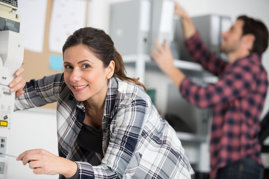 young repairer woman fixing printer