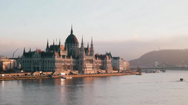 Beautiful footage of the Hungarian parliament building and a ferry moving across the Danube River.