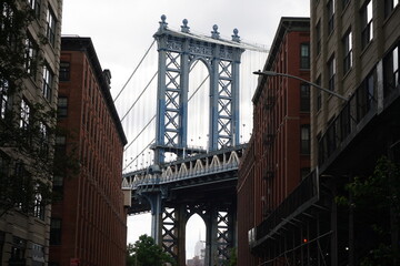 Fototapeta premium Manhattan Bridge tower framed by urban street in DUMBO New York