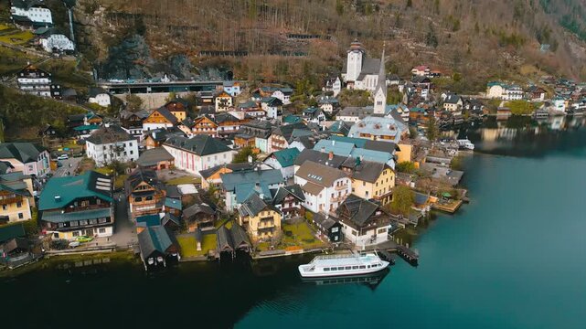 High-altitude drone establishing 4K cinematic footage of Hallstatt, Austria surrounded by the snow-covered Austrian Alps in winter.