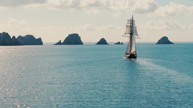 Sailing ship heading toward Tas de Pois rocks near Camaret-sur-Mer, Brittany, France