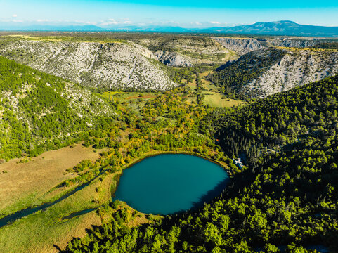 Aerial view of the confluence where the Cikola river lake drom torak view tributary joins the Krka river canyon, Krka National Park, Dalmatia, Croatia.