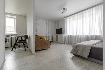 Fototapeta premium Modern Open Plan Studio Apartment with Kitchen and Bedroom