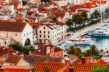Naklejka premium Traditional Mediterranean stone houses and red terracotta roofs in the historic center of Hvar town, Croatia from medieval Spanish Fortress.