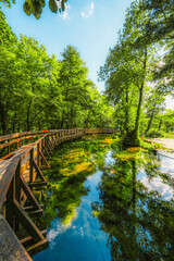 Fototapeta premium Wooden bridge over the emerald waters of Plivsko Lake, known as the 