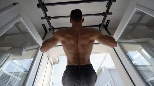 Man Performing Pull Ups at Home.