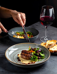 Chef Plating Gourmet Beef Steak Dish with Red Wine Fine Dining Restaurant
