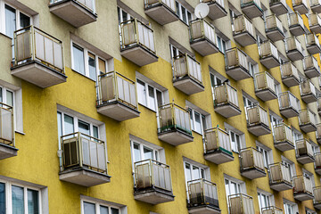 Old obsolete block building with yellow balconies. Soviet architecture in Europe	