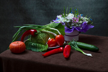 Still life with vegetables and a bouquet of flowers