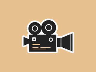 A simple graphic illustration of a black film camera on a yellow background