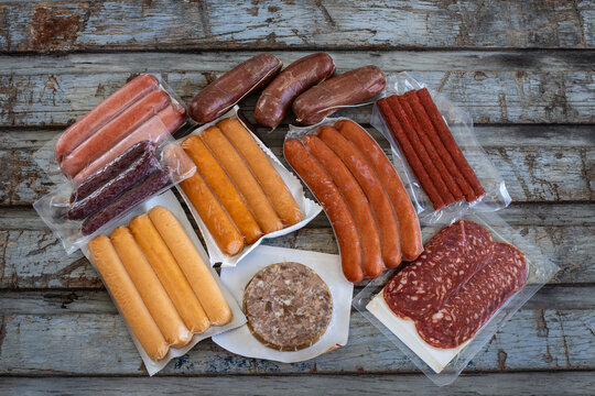 Vacuum sealed dried meats in the paper shopping bag.  Shopping from delicatessen concept. 