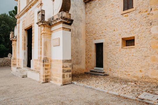 Detail of Egl&eacute;sia del Calvari facade and adjoining stone house