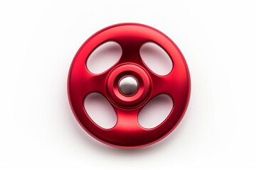 Fototapeta premium Red aluminum fidget spinner toy resting on a white studio background