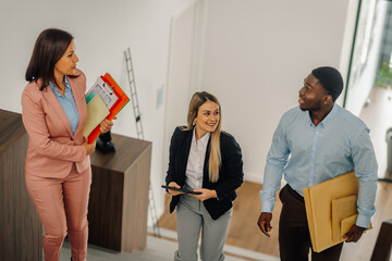 Business colleagues walking upstairs discussing new project