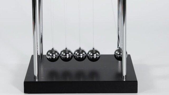 Close Up of Hand Starting Motion on a Newton's Cradle