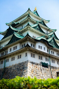Traditional Japanese castle architecture in Nagoya with fresh spring greenery
