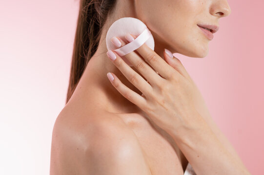 Portrait Woman with clear glowing skin on soft pink background