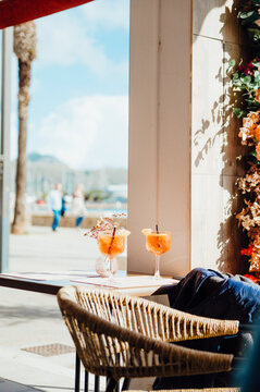 Aperol Spritz cocktails on caf&eacute; table in Port de Pollen&ccedil;a, Mallorca