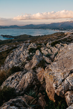 Rocky ridge above Port de Pollen&ccedil;a and Alc&uacute;dia Bay at sunrise