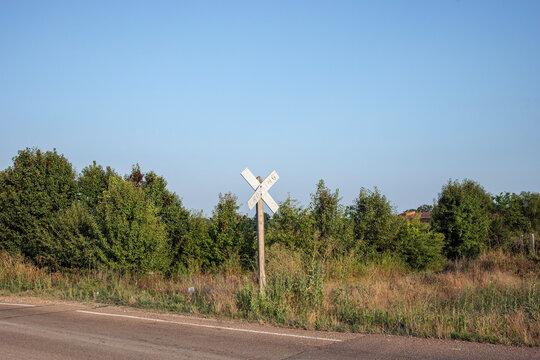 Defunct railroad crossing sign on rural country road