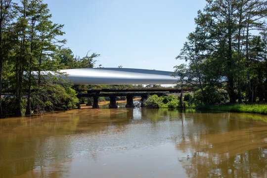 Wind turbine blade being transported by rail over a river