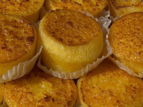 Closeup of traditional Portuguese Queijada de Vouzela (Cheesecake of Vouzela) pastries on a bakery stall at a food market in Portugal