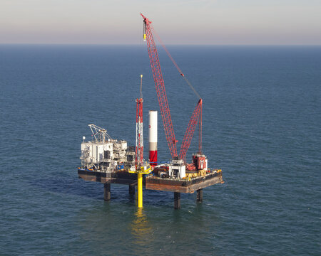 Netherlands, Netherlands - 13 February 2026: Aerial view of a colossal offshore platform rising from the sea, a stark contrast of industrial steel against the serene blue horizon.