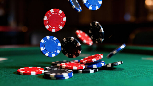 Casino poker chips falling onto a green felt table in a dynamic motion blur
