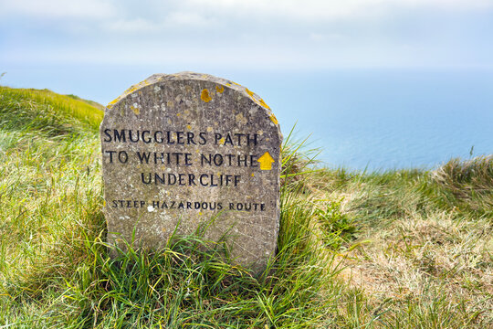 Stone marker sign for the Smugglers Path on the Dorset coast. Setting for the popular 1898 book Moonfleet.