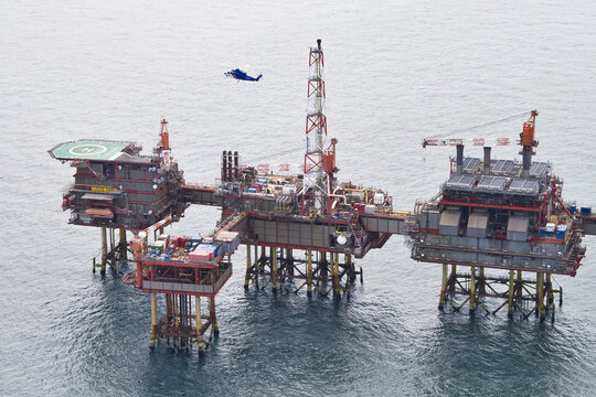 United Kingdom, United Kingdom - 15 February 2026: Aerial view of a sprawling offshore oil rig platform, a metallic titan amidst the serene, undulating ocean waves.