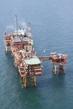 United Kingdom, United Kingdom - 15 February 2026: Aerial view of a platform with a helipad standing defiant against the vast, deep-blue sea, a testament to human engineering.