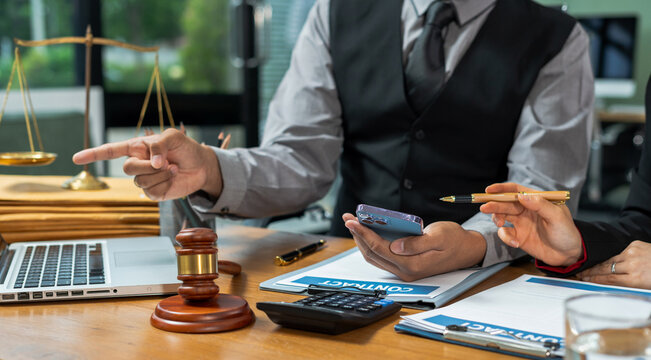 Teamwork of business lawyer meeting working hard about legal legislation in courtroom to help their customer.