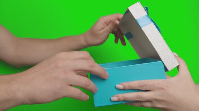 Woman Giving a Sealed Gift Box Containing 1 and 2 Bills to a Man, Who Counts the Money, Places It Back in the Box, and Takes the Gift, Green Screen Video