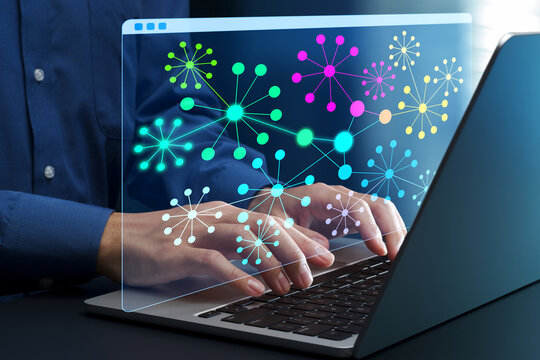 Knowledge graph. Semantic network for knowledge and data management. Businessperson using laptop computer to access knowledge base at desk in office.