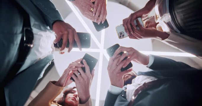 Business people, hands or circle with phone for network, data sync or sharing app below in office. Low angle, group or employees with mobile smartphone, connection or huddle for social media platform