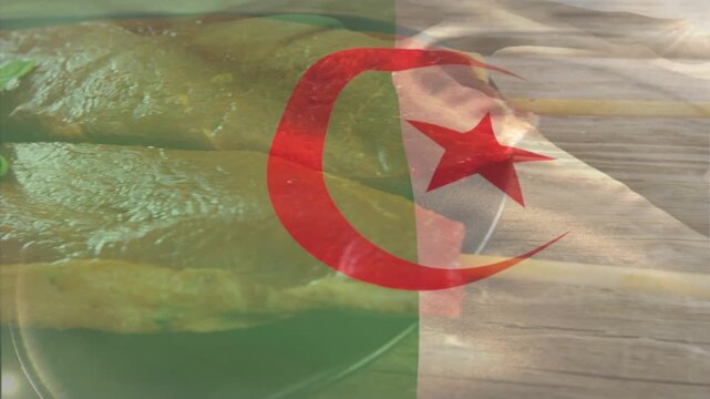 Hand entering right, arranging cooked fillets and placing basil to plate, Algerian flag sweeping
