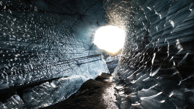 View of a mesmerizing ice cave with glistening blue textures and a luminous opening beckoning towards the light, Reykjav&Atilde;&shy;k, Reykjav&Atilde;&shy;kurborg, Iceland.