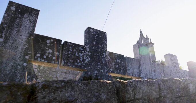 A large stone cross is on a wall