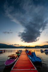 Fototapeta premium Boats at the pier Lake Schluchsee in the Black Forest in Southern Germany during beautiful sunset