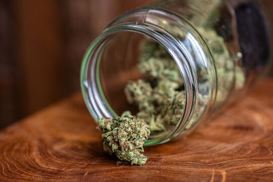 Glass jar full of freshly dried cannabis marijuana buds
