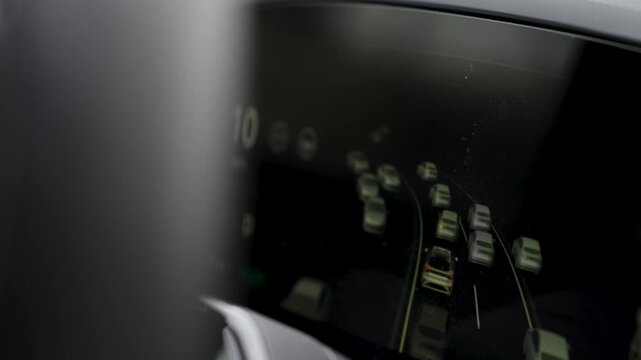 Close-up of EV Digital Dashboard with Autopilot Traffic Visualization. Electric vehicle digital display showing real-time 3D traffic monitoring, including surrounding cars and lane detection