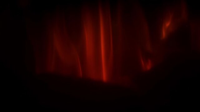 Detailed slow motion shot of flames expanding across controlled surfaces on a dark background suitable as fire overlay footage.