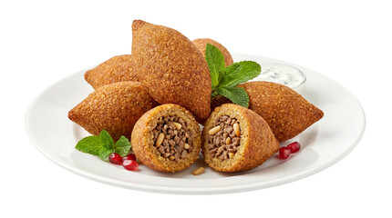 Kibbeh fried bulgur croquettes with minced meat, pine nuts, and pomegranate seeds on white plate with mint garnish