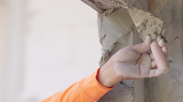 Close up damaged cement plaster on wall corner with rough texture. Construction repair, renovation process and structural maintenance concept with copy space.