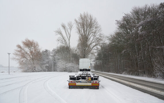 Truck parked on snowy roadside near Rotterdam in winter