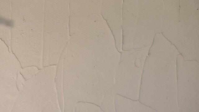 Wet cement plaster applied over concrete block wall during renovation. Industrial construction texture, gray surface background and structural repair concept.