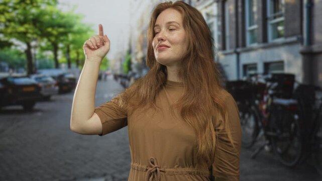 Woman in brown shirt points finger to building on a bustling urban street; clarity confidence vision.