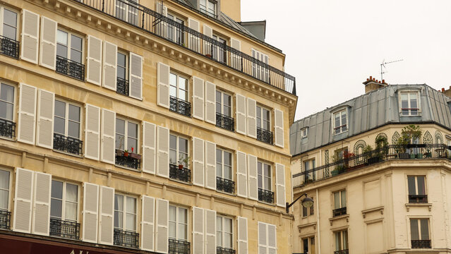 Parisian haussmann architecture with classic balcony details and tall windows, iconic buildings representing french urban life
