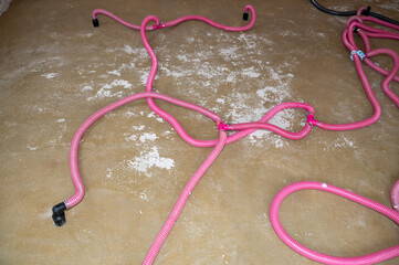 Floor drying after a burst water pipe using a dehumidifier with water damage restoration pipes